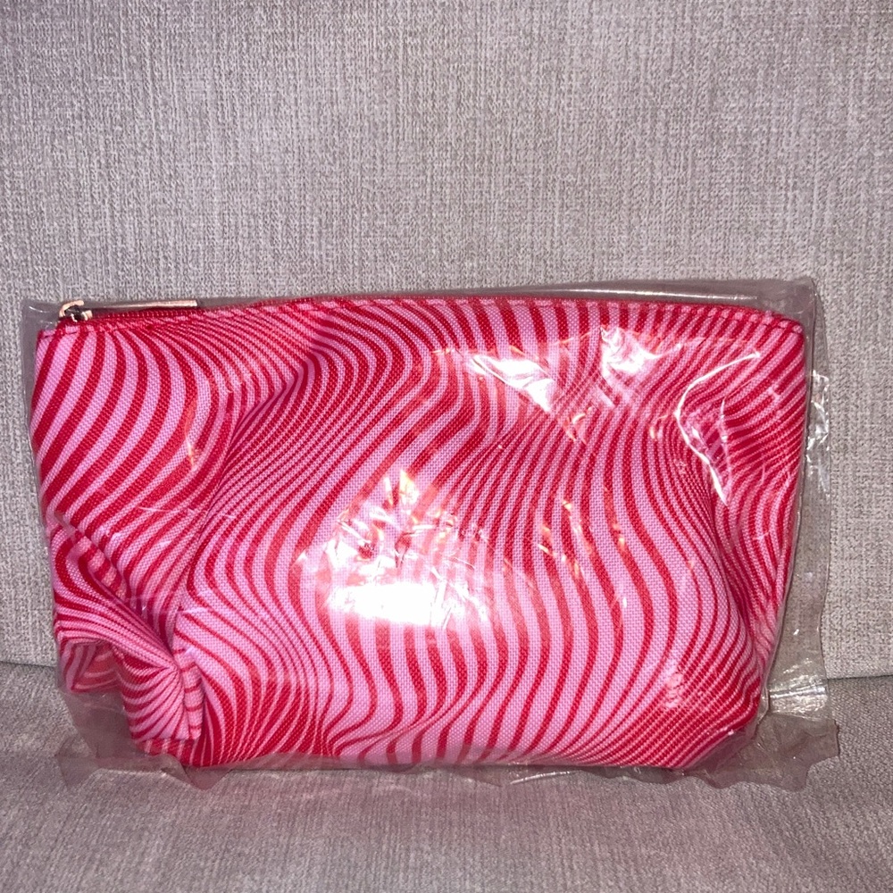 CLINIQUE Pink and Red Striped Cosmetic Bag with Clinique products.